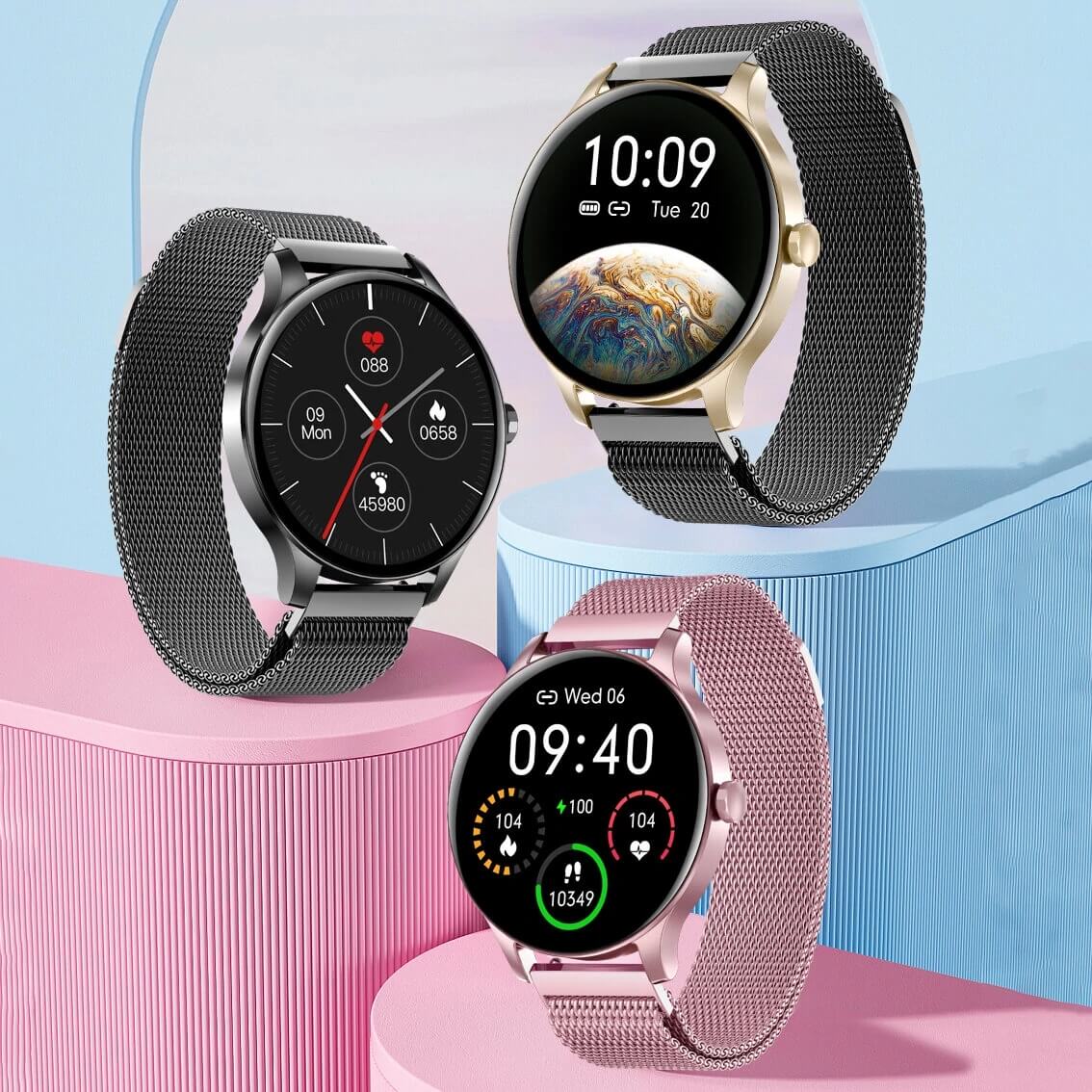Three smartwatches with mesh bands on pink and blue stands