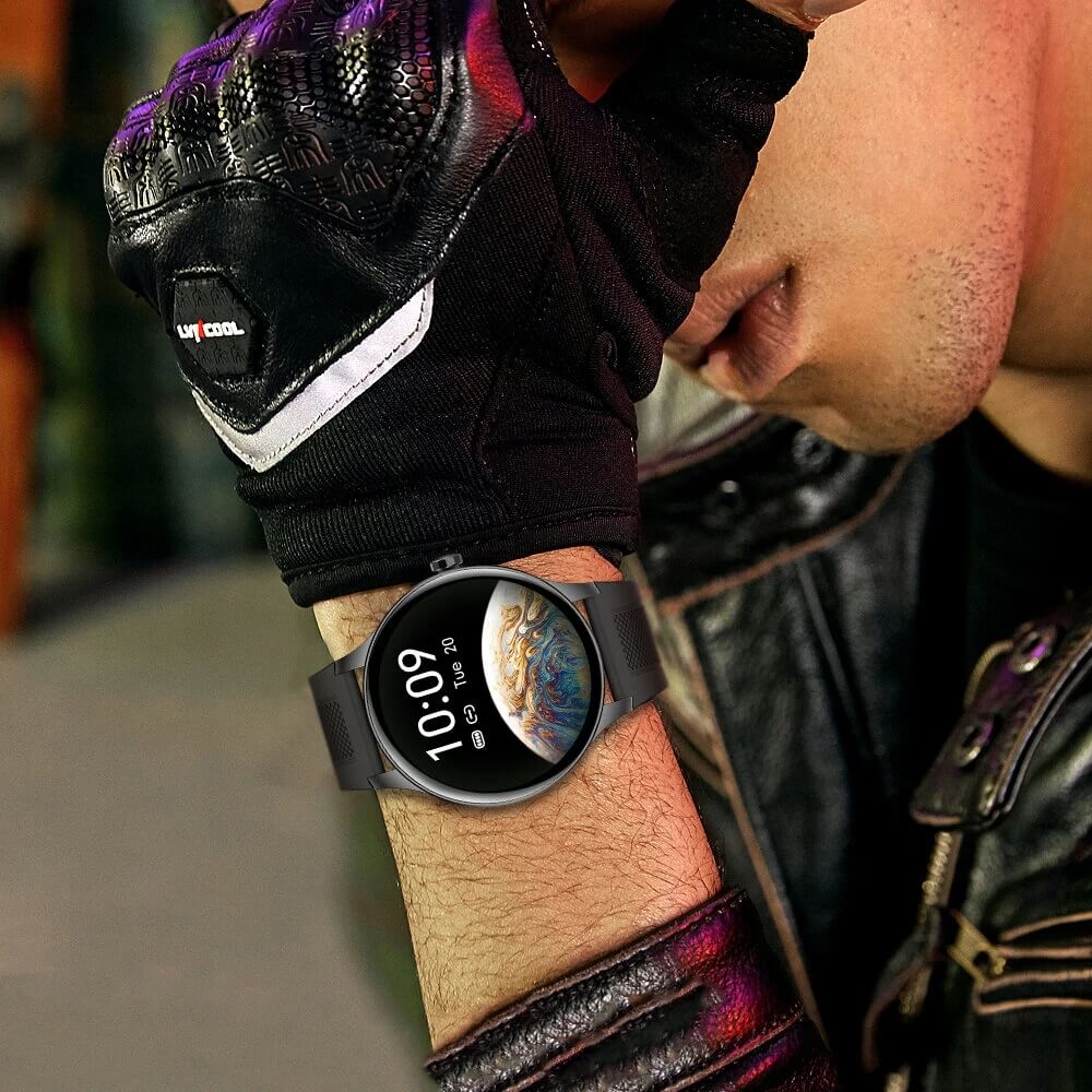 Person wearing a smartwatch with a colorful display on a blurred background